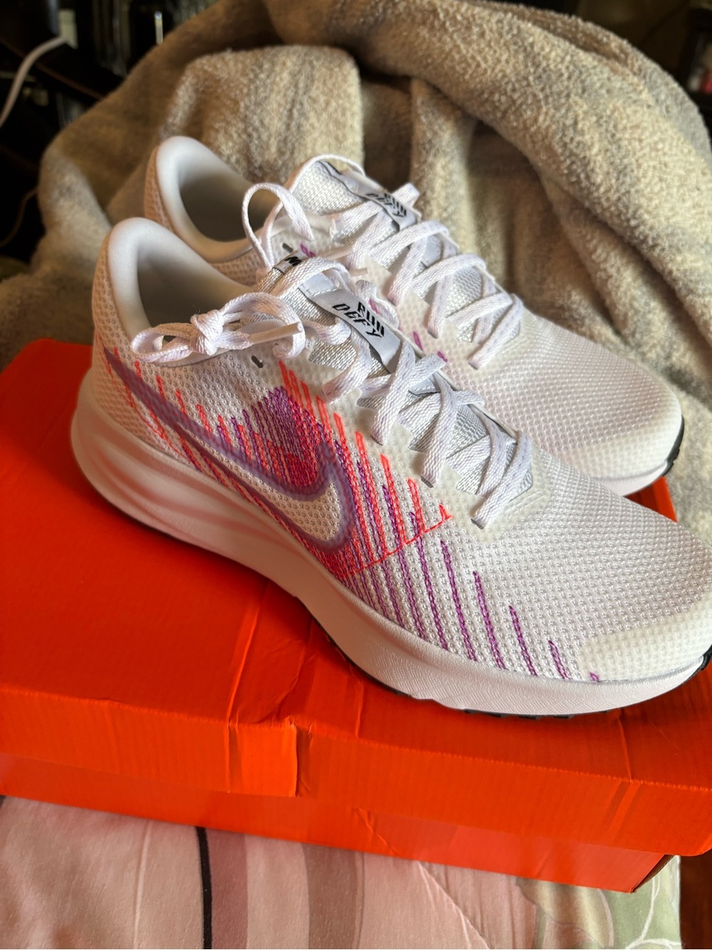 Nike -DEFY-Women's White Running Shoes with Pink & Orange Accent